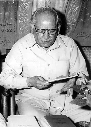 Faiz Ahmed Faiz reading at his desk