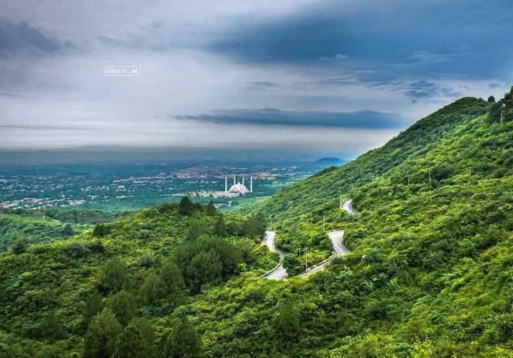 The green Margalla Hills with the Faisal Mosque and Islamabad below